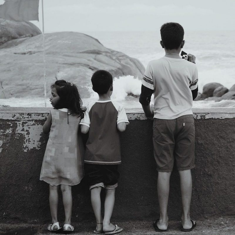 Three children at the sea — Explore, Play, Love